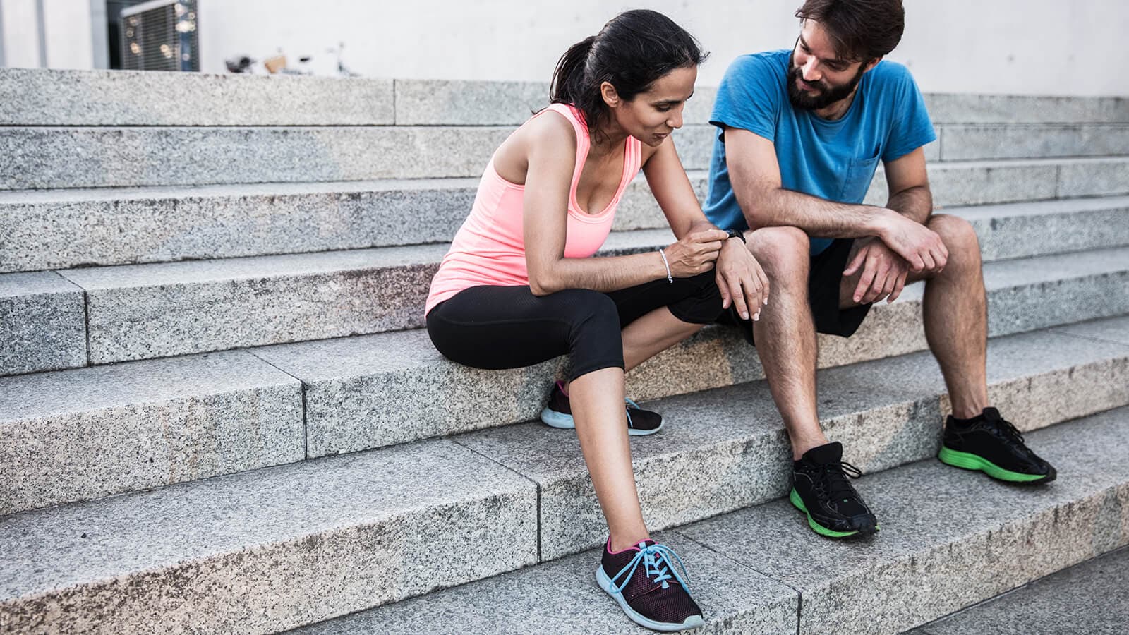 Zwei Läufer sitzen auf einer Treppe