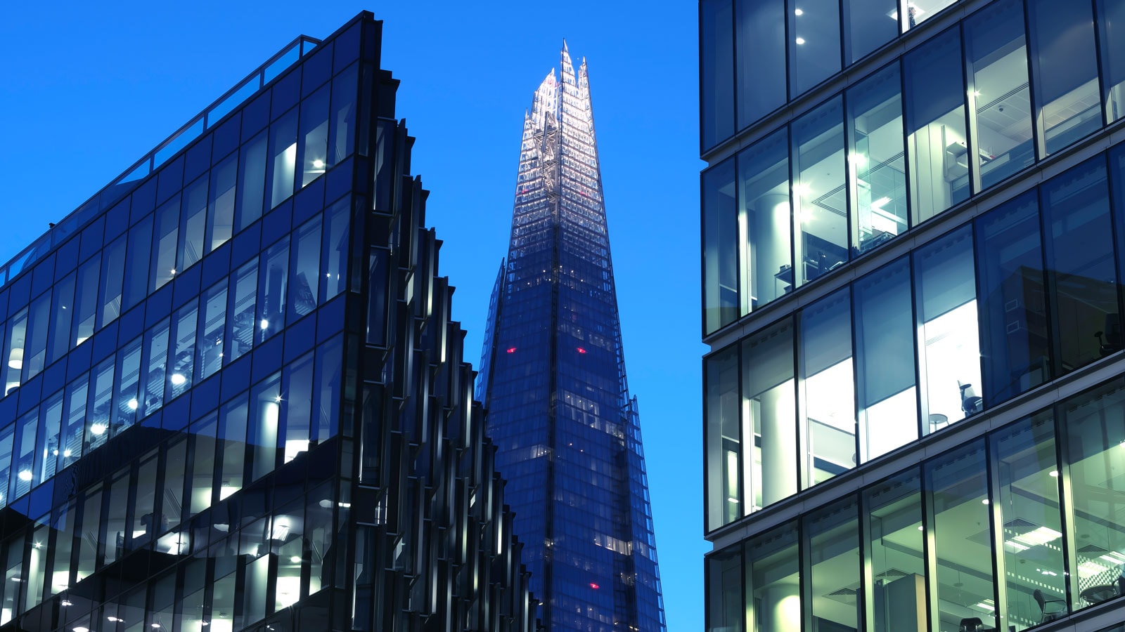 Modern offices and skyscrapers lit up at dusk