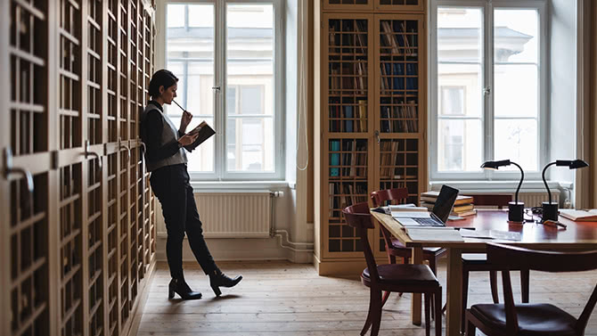 Thoughtful lawyer holding a book