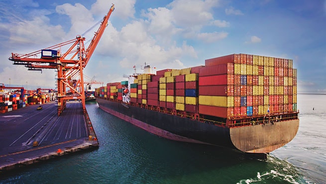 Aerial view of cargo ship in transit highlighting supply chain disruptions and trade risks facing Ghana economy